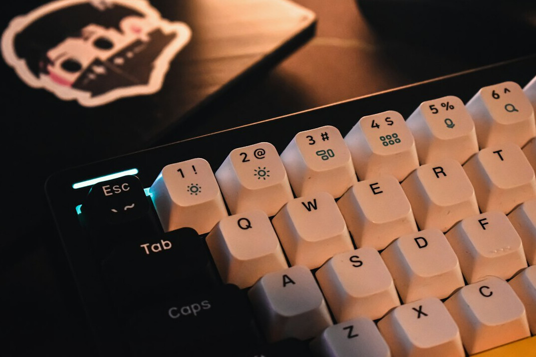 Close-up of hands typing on a mechanical keyboard